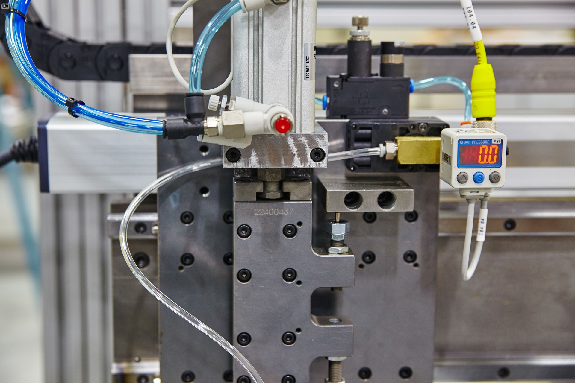 Industrial Pressure Gauge and Pneumatic Cylinder Close-Up